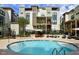 Community pool with stairs and seating surrounded by townhomes and well-manicured landscaping at 35 Moda Ln, Atlanta, GA 30316