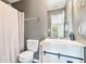 This bathroom has gray walls, a shower, a white sink cabinet with black hardware, and wood-look shelves at 4180 West Stubbs Rd, College Park, GA 30349