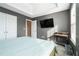 Bedroom featuring a tray ceiling, gray walls, carpet, a desk, and a television mounted to the wall at 4180 West Stubbs Rd, College Park, GA 30349
