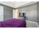 Bedroom featuring a tray ceiling, gray walls, carpet, a bed, and a television on top of a cabinet at 4180 West Stubbs Rd, College Park, GA 30349