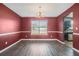 Cozy dining room with dark-toned walls and view to backyard at 4180 West Stubbs Rd, College Park, GA 30349