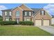 Charming brick home featuring a well-maintained lawn and an attached two-car garage at 4180 West Stubbs Rd, College Park, GA 30349