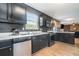 Modern kitchen with black cabinetry, stainless steel appliances, and lots of natural light at 4180 West Stubbs Rd, College Park, GA 30349