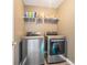 Efficient laundry room featuring modern stainless steel appliances and organized shelving at 4180 West Stubbs Rd, College Park, GA 30349