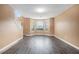 Airy living room features new flooring and views from the large bay windows for natural light at 4180 West Stubbs Rd, College Park, GA 30349