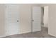 Hallway featuring white doors, providing access to different areas of the house at 9032 Jim Purcell Dr, Covington, GA 30014