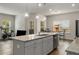 Open-concept kitchen with stainless steel appliances, granite countertops, and a central island at 9032 Jim Purcell Dr, Covington, GA 30014