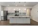 Modern kitchen with stainless steel appliances, gray cabinets, granite countertops, and a large island at 9032 Jim Purcell Dr, Covington, GA 30014