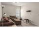 Comfortable living room with plush brown sectional sofa and ottoman, perfect for relaxing and entertaining at 9032 Jim Purcell Dr, Covington, GA 30014