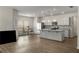 Open-concept living space with kitchen island and hardwood floors at 9032 Jim Purcell Dr, Covington, GA 30014
