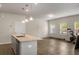Open-concept living space and kitchen area with hardwood floors and modern decor at 9032 Jim Purcell Dr, Covington, GA 30014