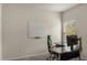 Office space featuring a whiteboard, a modern desk, and a large window at 9032 Jim Purcell Dr, Covington, GA 30014