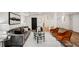 Basement with living area, including gray sofa and orange chairs and modern decor at 2685 Glenvalley Dr, Decatur, GA 30032