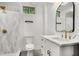 Modern bathroom features white cabinets, marble counters and sleek fixtures at 2685 Glenvalley Dr, Decatur, GA 30032