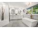 Modern bathroom with double vanity, marble countertops, and a standalone bathtub at 2685 Glenvalley Dr, Decatur, GA 30032