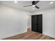 Bedroom featuring hardwood floors, a ceiling fan, recessed lighting, and black closet doors at 2685 Glenvalley Dr, Decatur, GA 30032