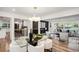 Open-concept dining and living area with hardwood floors, modern decor, and recessed lighting at 2685 Glenvalley Dr, Decatur, GA 30032
