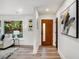Bright entryway featuring modern decor, a wood door with glass, and sleek wood floors at 2685 Glenvalley Dr, Decatur, GA 30032