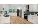 Modern kitchen with stainless steel appliances, white cabinets, and a stylish backsplash at 2685 Glenvalley Dr, Decatur, GA 30032