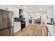 Updated kitchen with stainless steel refrigerator and view to open living spaces at 2685 Glenvalley Dr, Decatur, GA 30032