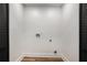 A laundry room space with new floors and connections for a washer and dryer at 2685 Glenvalley Dr, Decatur, GA 30032
