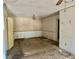 An empty living room with floral wallpaper and damaged floors at 3038 Parc Lorraine, Lithonia, GA 30038