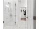 Sleek bathroom showcasing a glass-enclosed shower with marble tiling and modern fixtures at 388 Pratt Se Dr # 2123, Atlanta, GA 30315