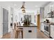 Modern kitchen features stainless steel appliances, gray cabinets, a black countertop island, and wood flooring at 388 Pratt Se Dr # 2123, Atlanta, GA 30315