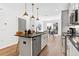 Modern kitchen with stainless appliances, center island, wood floors, and an open floor plan to dining area at 388 Pratt Se Dr # 2123, Atlanta, GA 30315