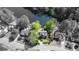 An aerial view of a brick home surrounded by lush greenery and lake, located within a private community at 4730 W Forest Peak, Marietta, GA 30066