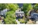 Aerial shot of a home with a large, beautifully landscaped yard nestled amongst lush trees near a serene lake at 4730 W Forest Peak, Marietta, GA 30066