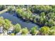 Stunning aerial view of homes nestled on a tree-lined lakefront property, offering serene waterfront living at 4730 W Forest Peak, Marietta, GA 30066