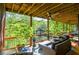 Spacious covered porch with outdoor seating, ceiling fans, and a view of the lake and lush greenery at 4730 W Forest Peak, Marietta, GA 30066