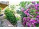 Landscaped backyard with stone path features vibrant azaleas and lush greenery leading to the lake at 4730 W Forest Peak, Marietta, GA 30066