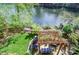 Outdoor seating area with a pergola and well-maintained lawn offers peaceful waterfront living at 4730 W Forest Peak, Marietta, GA 30066