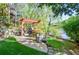 Beautiful backyard features a pergola with outdoor seating and grill area near the tranquil lake at 4730 W Forest Peak, Marietta, GA 30066