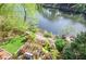 Picturesque backyard with lush greenery, a lakeside lawn, and a charming pergola patio area at 4730 W Forest Peak, Marietta, GA 30066