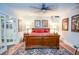 Well-lit bedroom with French doors, hardwood floors, ceiling fan, and warm decorative lamps at 4730 W Forest Peak, Marietta, GA 30066