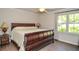 Cozy bedroom with hardwood floors, a queen-sized bed, and bright natural light from a window at 4730 W Forest Peak, Marietta, GA 30066