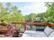 Relaxing deck overlooking a serene lake, complete with lounge chairs, a wooden railing and lush greenery at 4730 W Forest Peak, Marietta, GA 30066