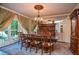 Formal dining room featuring a chandelier, large window, and seating for eight, perfect for entertaining at 4730 W Forest Peak, Marietta, GA 30066
