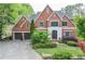 Beautiful brick home featuring an attached two-car garage and a meticulously landscaped front yard at 4730 W Forest Peak, Marietta, GA 30066