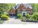 Attractive two-story brick home with a symmetrical facade, an attached garage, and manicured landscaping at 4730 W Forest Peak, Marietta, GA 30066