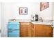 Charming kitchenette featuring a retro blue mini-fridge, granite countertops, and a convenient coffee maker at 4730 W Forest Peak, Marietta, GA 30066