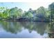 Picturesque lake view showcases the home's serene setting surrounded by lush trees and nature at 4730 W Forest Peak, Marietta, GA 30066
