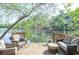 A cozy wooden deck with comfortable outdoor furniture, steps leading down to a lake at 4730 W Forest Peak, Marietta, GA 30066