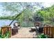 Wooden deck overlooking the lake features cozy seating, creating an inviting space to relax and unwind at 4730 W Forest Peak, Marietta, GA 30066