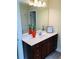 Bathroom vanity featuring dark wood cabinets, white countertop, decorative vase, and a large mirror at 533 Mount Gerizim Se Rd, Mableton, GA 30126