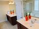 Bathroom featuring double vanities with white countertops, dark wood cabinets, and modern fixtures at 533 Mount Gerizim Se Rd, Mableton, GA 30126