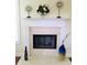 Marble fireplace mantel with decorative art pieces, flowers, and blue vase, offering an elegant focal point at 533 Mount Gerizim Se Rd, Mableton, GA 30126